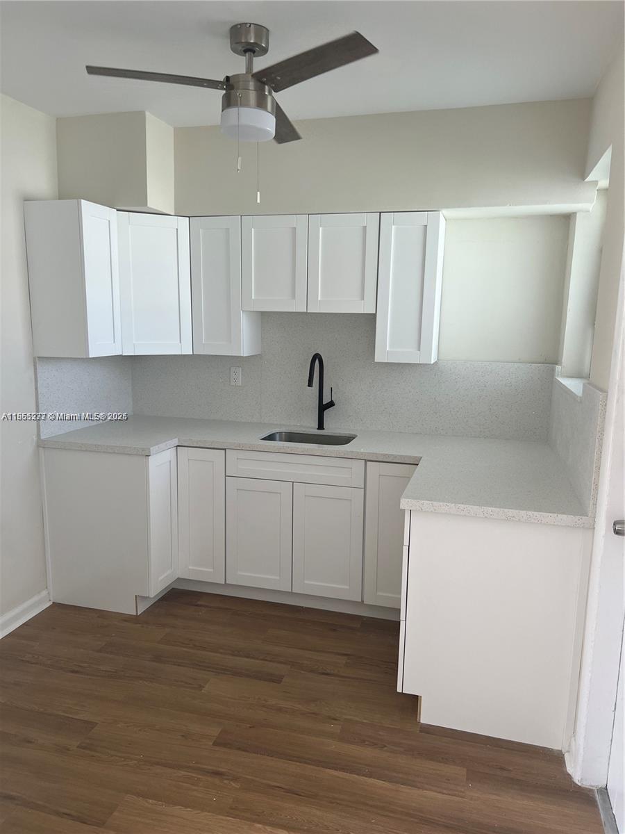 315 83rd Street, Unit 10 Miami Beach, FL 33141 - Photo 3 of 8 a kitchen with a sink window and cabinets