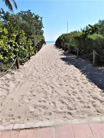 a view of a backyard of a house with a yard