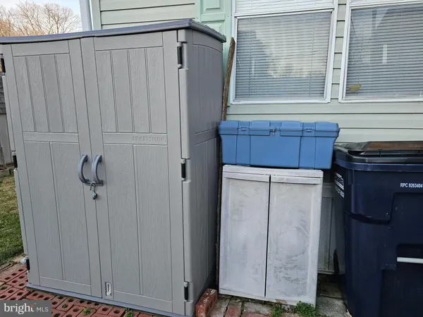 a view of a storage and utility room with washer and dryer