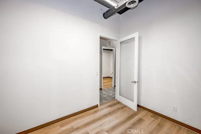 a view of a room with wooden floor