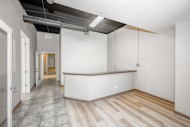 a view of a room with wooden floor