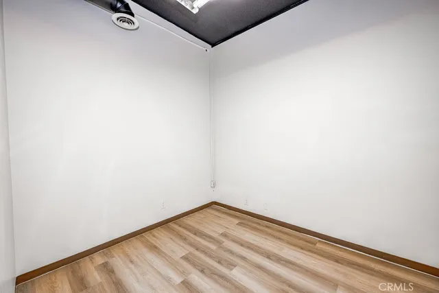 a view of a room with wooden floor