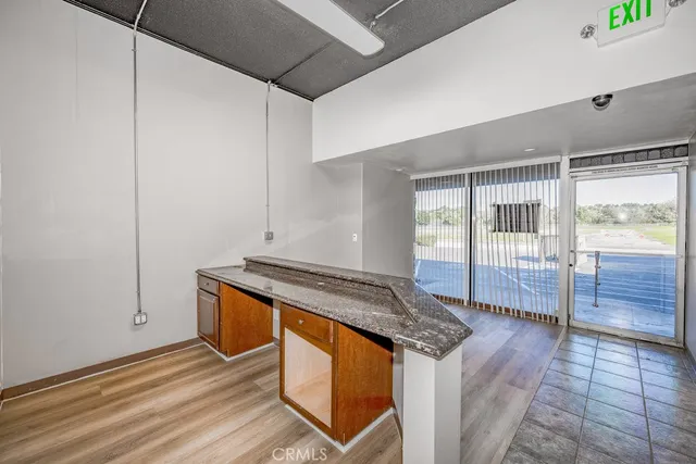 a kitchen with granite countertop a sink and a stove