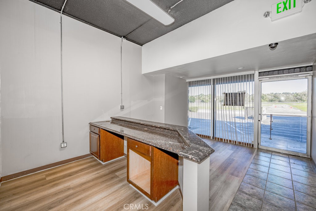 24609 Arch Street Newhall, CA 91321 - Photo 3 of 22 a kitchen with granite countertop a sink and a stove