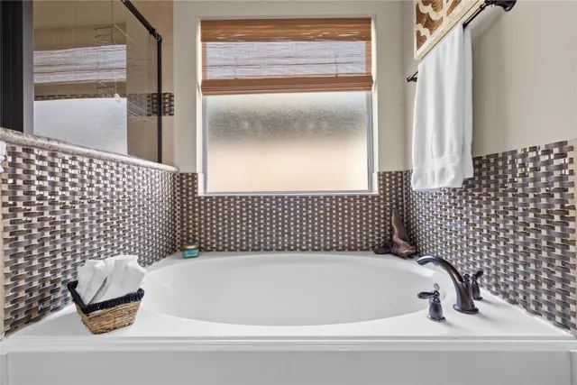 a bathroom with a bathtub and shower