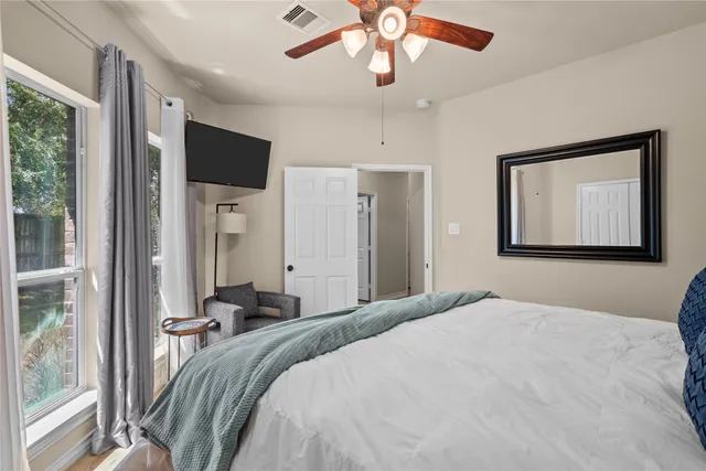 a bedroom with a large bed and a chandelier