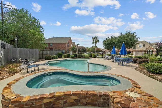 a view of a swimming pool with a patio