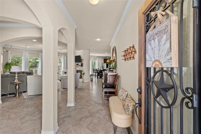 a view of a hallway with dining area and glass doors