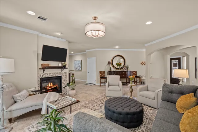 a living room with furniture a fireplace and a flat screen tv
