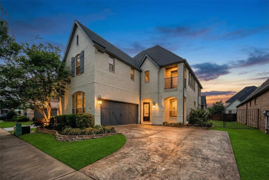 1039 Stephen Street Allen, TX 75013 - Photo 2 of 40 French country inspired facade featuring an attached garage, a balcony, driveway, and brick siding