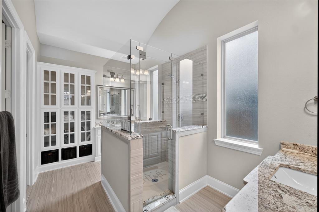 1039 Stephen Street Allen, TX 75013 - Photo 24 of 40 Full bath featuring a stall shower, vanity, a walk in closet, and light wood-style flooring