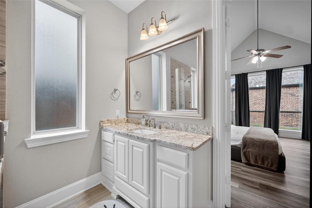 1039 Stephen Street Allen, TX 75013 - Photo 26 of 40 Bathroom with ensuite bathroom, light wood finished floors, vanity, ceiling fan, and lofted ceiling