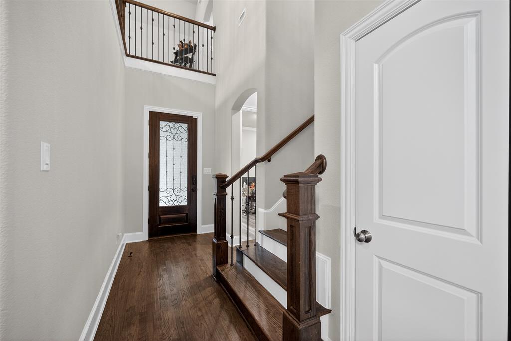 1039 Stephen Street Allen, TX 75013 - Photo 6 of 40 Foyer entrance with a high ceiling, dark wood-type flooring, and arched walkways