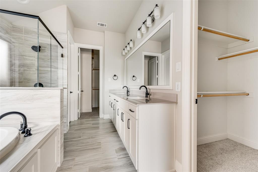 1905 Graham Way Mansfield, TX 76063 - Photo 16 of 20 a en suite bathroom with a granite countertop double vanity sink a mirror and a shower