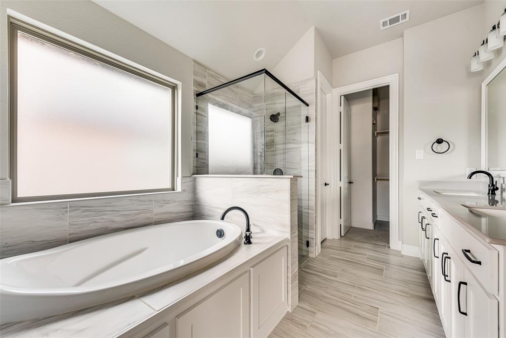 1905 Graham Way Mansfield, TX 76063 - Photo 17 of 20 a spacious bathroom with a granite countertop sink mirror and a bathtub