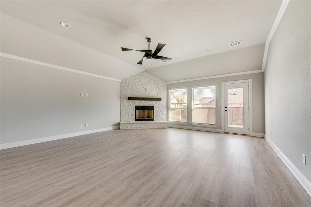 1905 Graham Way Mansfield, TX 76063 - Photo 4 of 20 a view of an empty room with wooden floor fireplace and a window