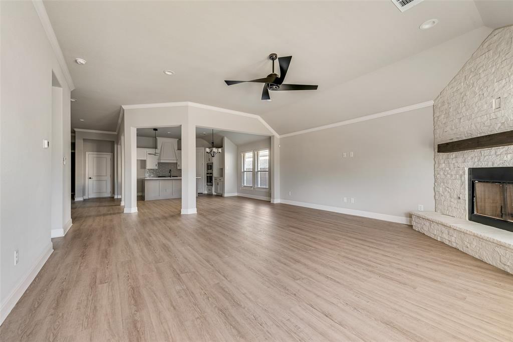 1905 Graham Way Mansfield, TX 76063 - Photo 5 of 20 an empty room with wooden floor fireplace and windows