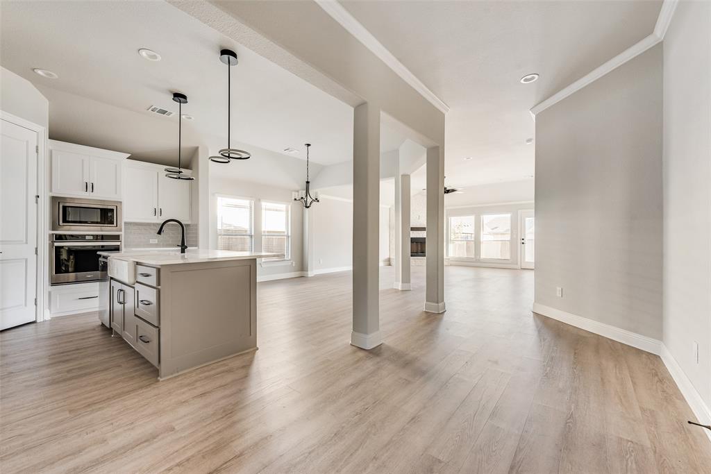 1905 Graham Way Mansfield, TX 76063 - Photo 7 of 20 a large kitchen with cabinets and wooden floor