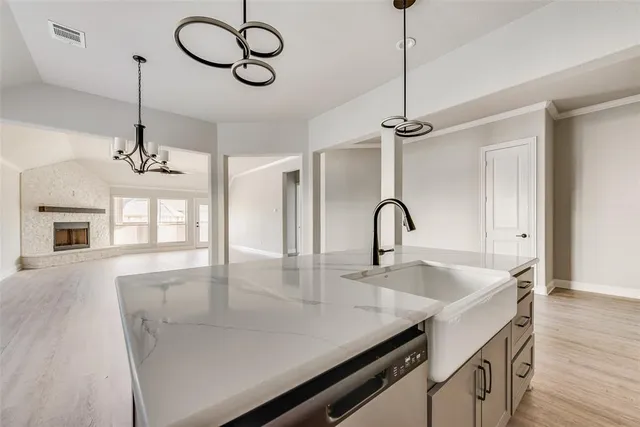 a view of a kitchen with a sink and chandelier