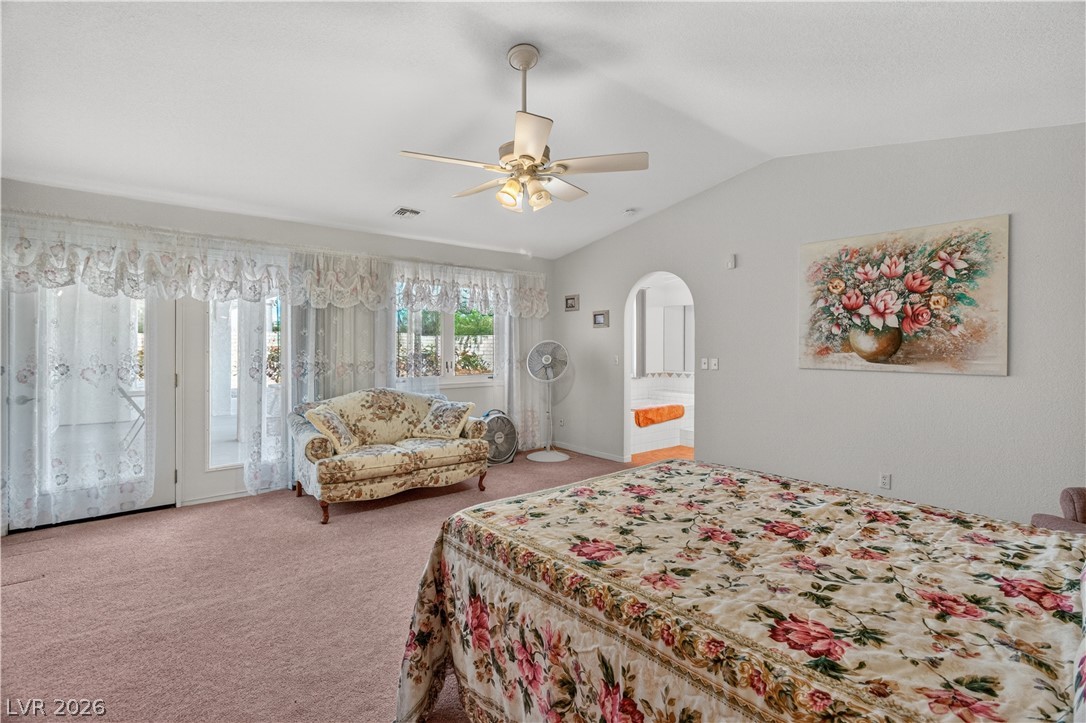 2055 Cholla Way Laughlin, NV 89029 - Photo 33 of 87 Archways lead to a private bath, while high vaulted ceilings create an open, airy feel in this bedroom.