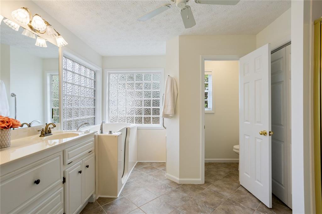 244 Kerry Drive Jasper, GA 30143 - Photo 11 of 24 a spacious bathroom with a double vanity sink a large mirror and a bathtub