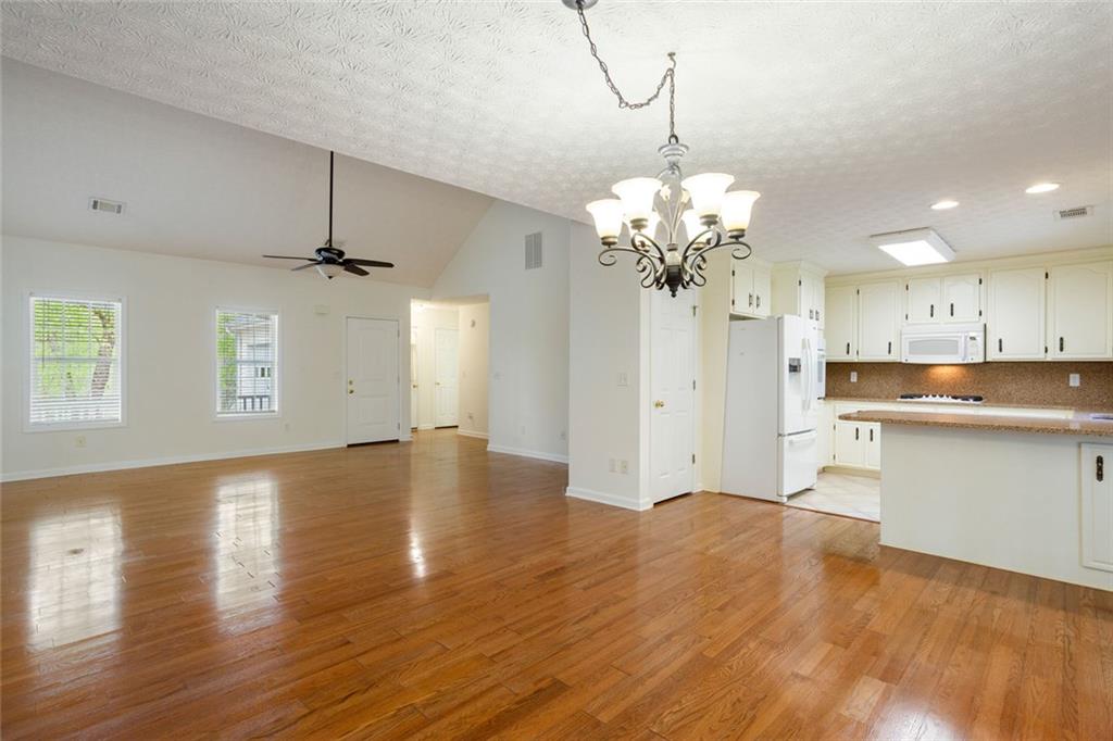 244 Kerry Drive Jasper, GA 30143 - Photo 6 of 24 a view of a kitchen with a dishwasher a kitchen island hardwood floor and a ceiling fan