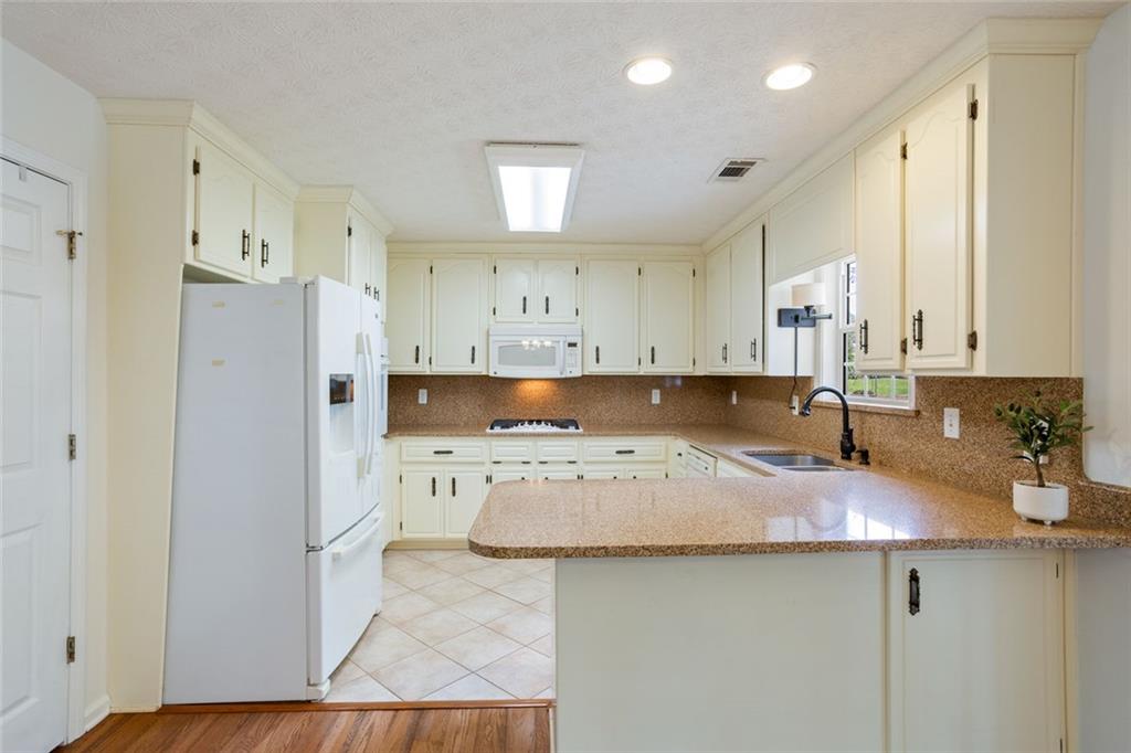 244 Kerry Drive Jasper, GA 30143 - Photo 8 of 24 a kitchen with a sink a stove a refrigerator and a cabinets
