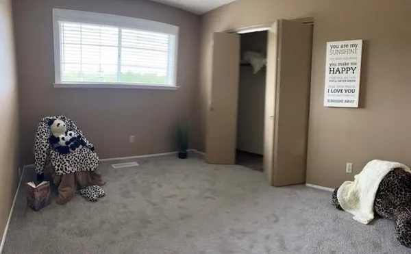a room with window and a baby crib