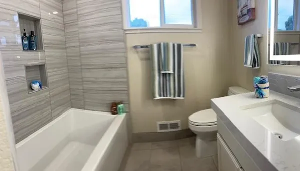 a bathroom with a sink a toilet and shower