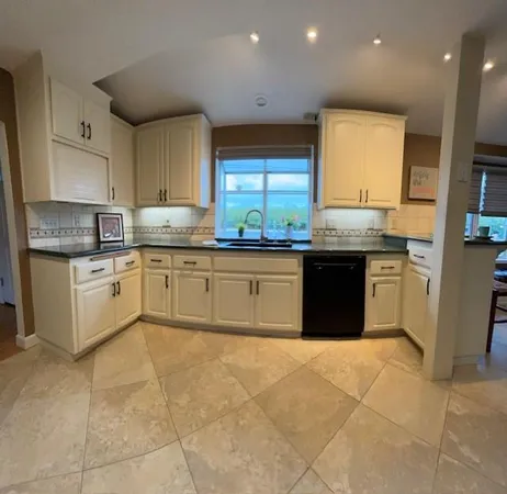 a kitchen with stainless steel appliances granite countertop a stove sink and cabinets