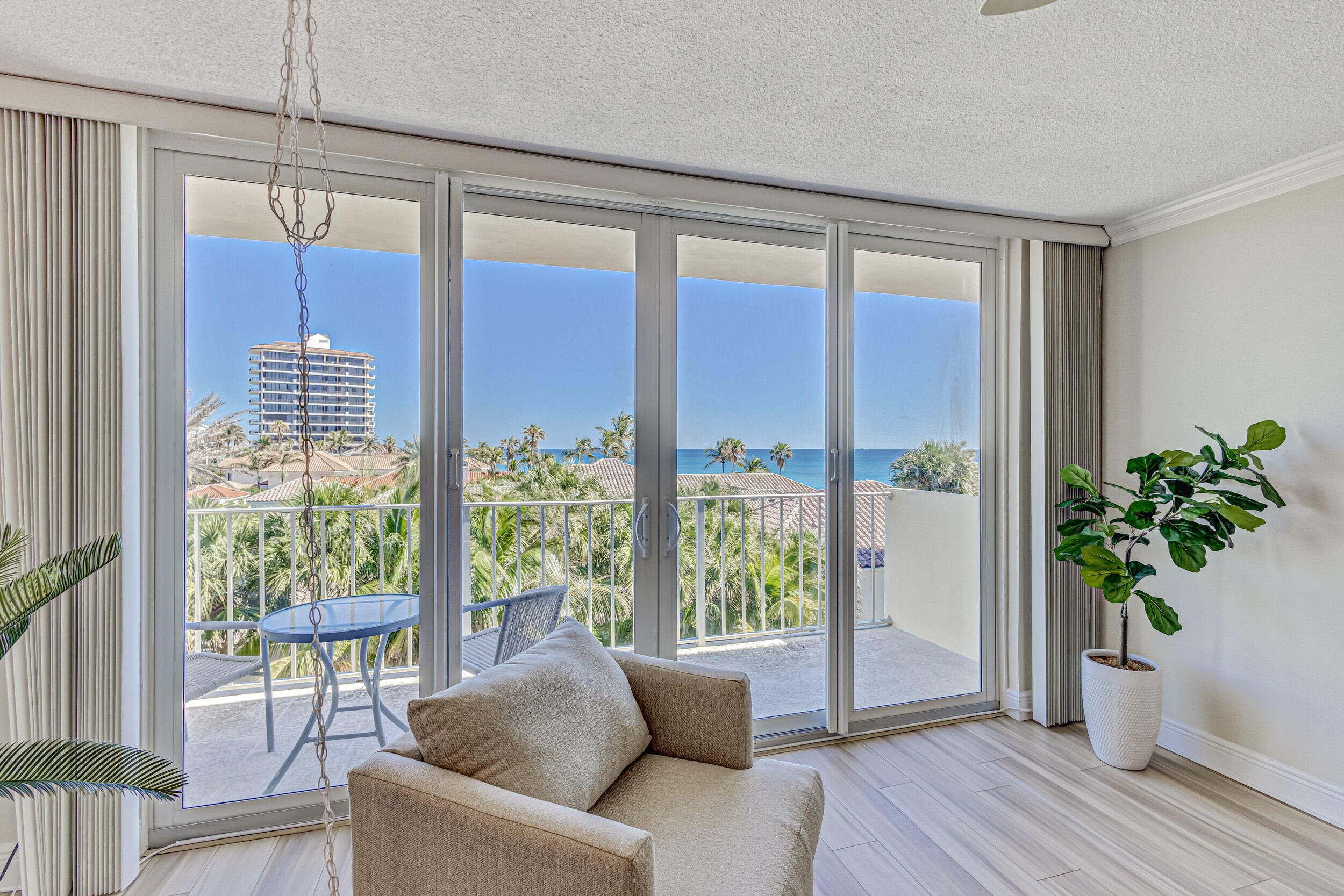 630 Ocean Drive, Unit 505 Juno Beach, FL 33408 - Photo 12 of 49 a living room with furniture and a potted plant