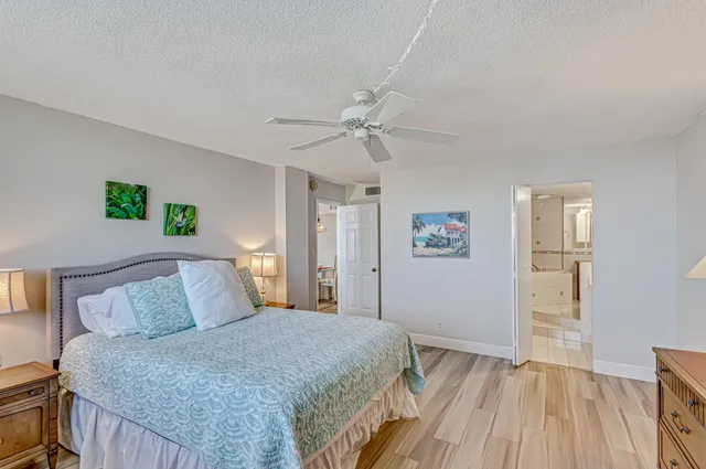 a bedroom with a bed and a ceiling fan
