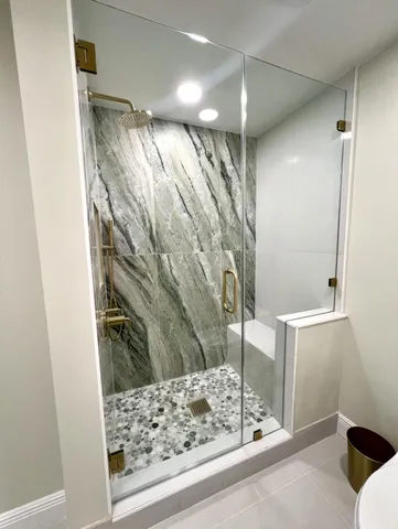 a bathroom with a bathtub and shower