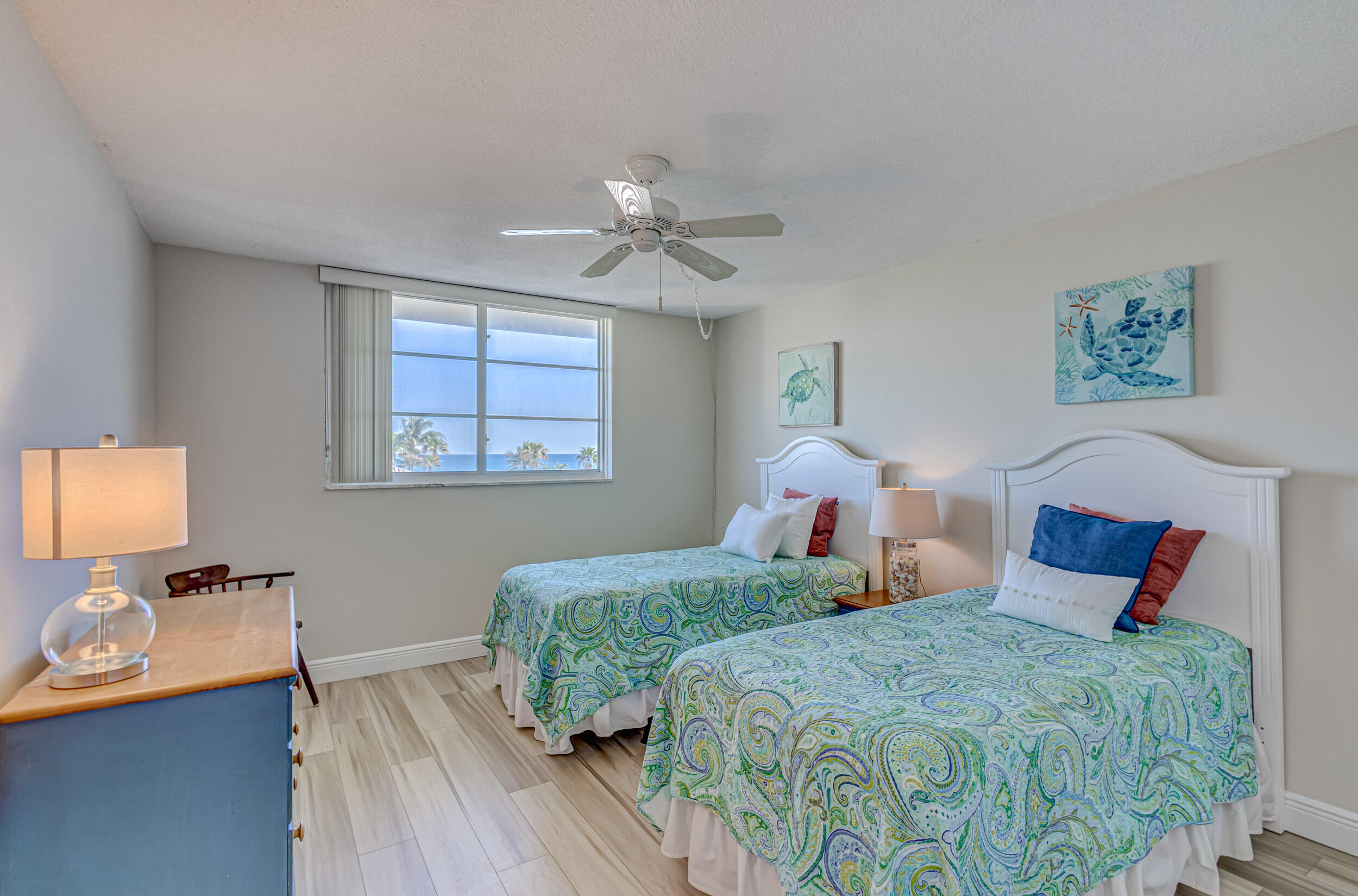 630 Ocean Drive, Unit 505 Juno Beach, FL 33408 - Photo 23 of 49 a bedroom with two beds and a chandelier
