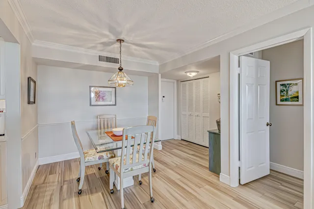 a dining room with furniture and wooden floor