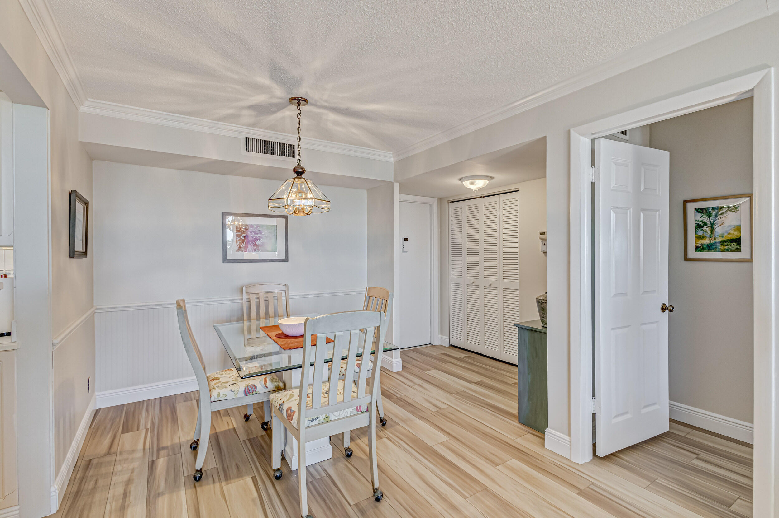 630 Ocean Drive, Unit 505 Juno Beach, FL 33408 - Photo 3 of 49 a dining room with furniture and wooden floor