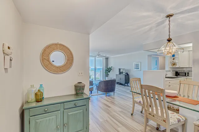 a view of a kitchen area with furniture and wooden floor
