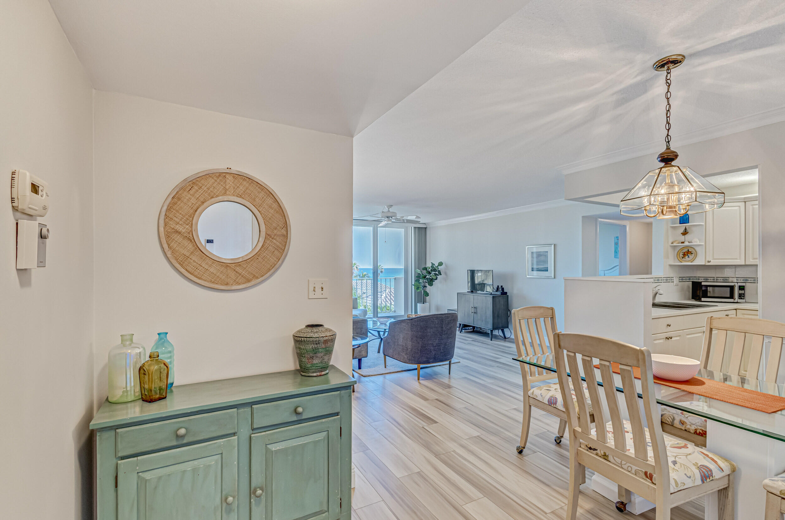 630 Ocean Drive, Unit 505 Juno Beach, FL 33408 - Photo 4 of 49 a view of a kitchen area with furniture and wooden floor