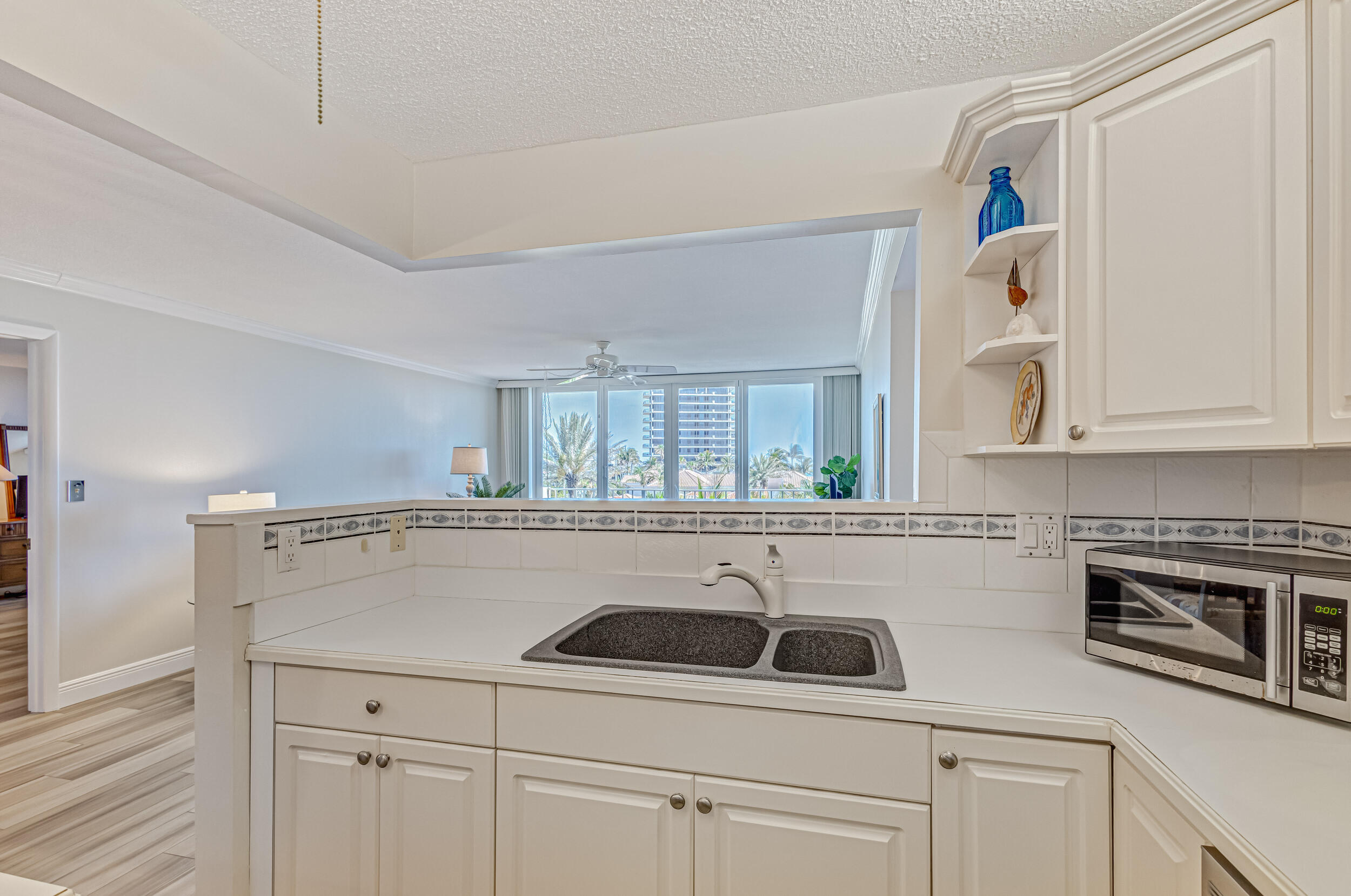 630 Ocean Drive, Unit 505 Juno Beach, FL 33408 - Photo 8 of 49 a kitchen with a sink and cabinets