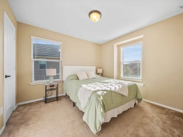 a bathroom with a granite countertop sink mirror vanity and toilet