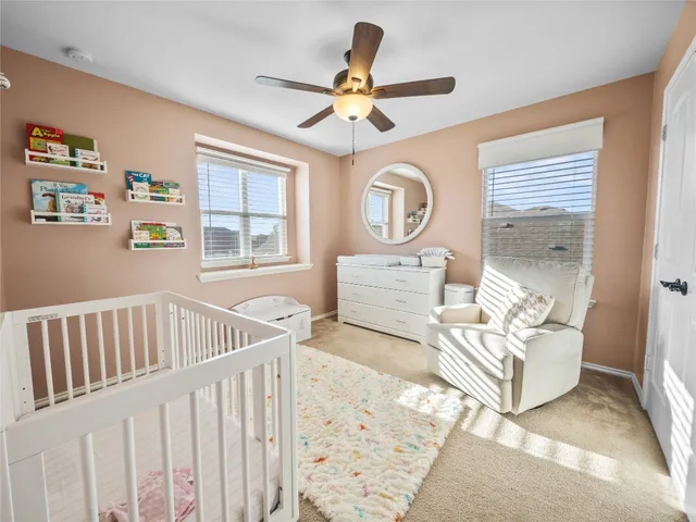 a living room with furniture and a ceiling fan