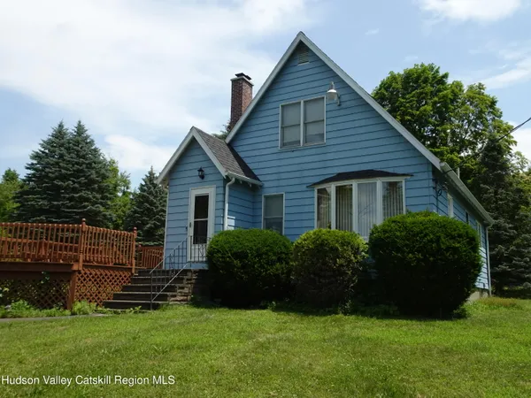 a front view of house with yard and green space