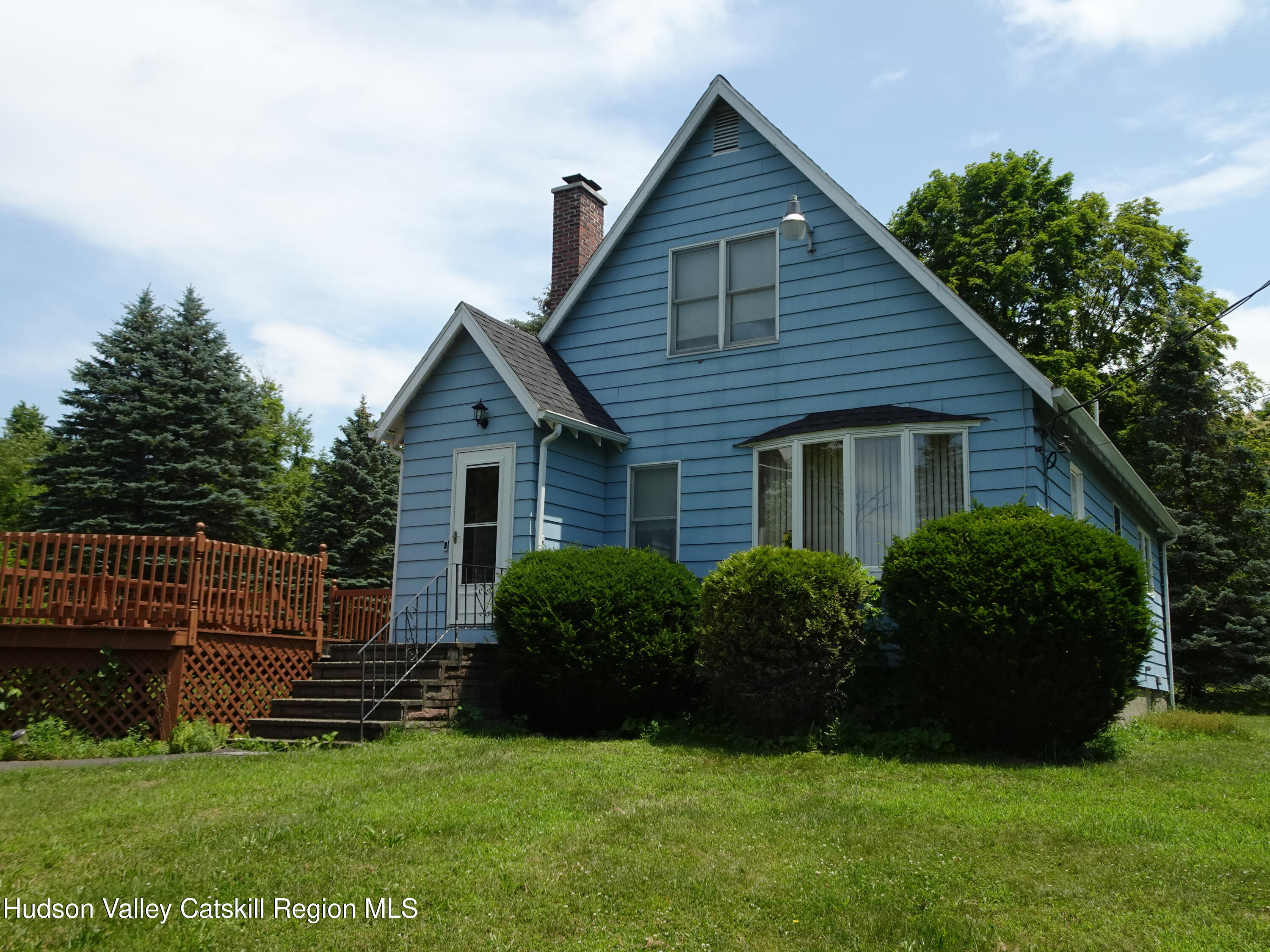 a front view of house with yard and green space