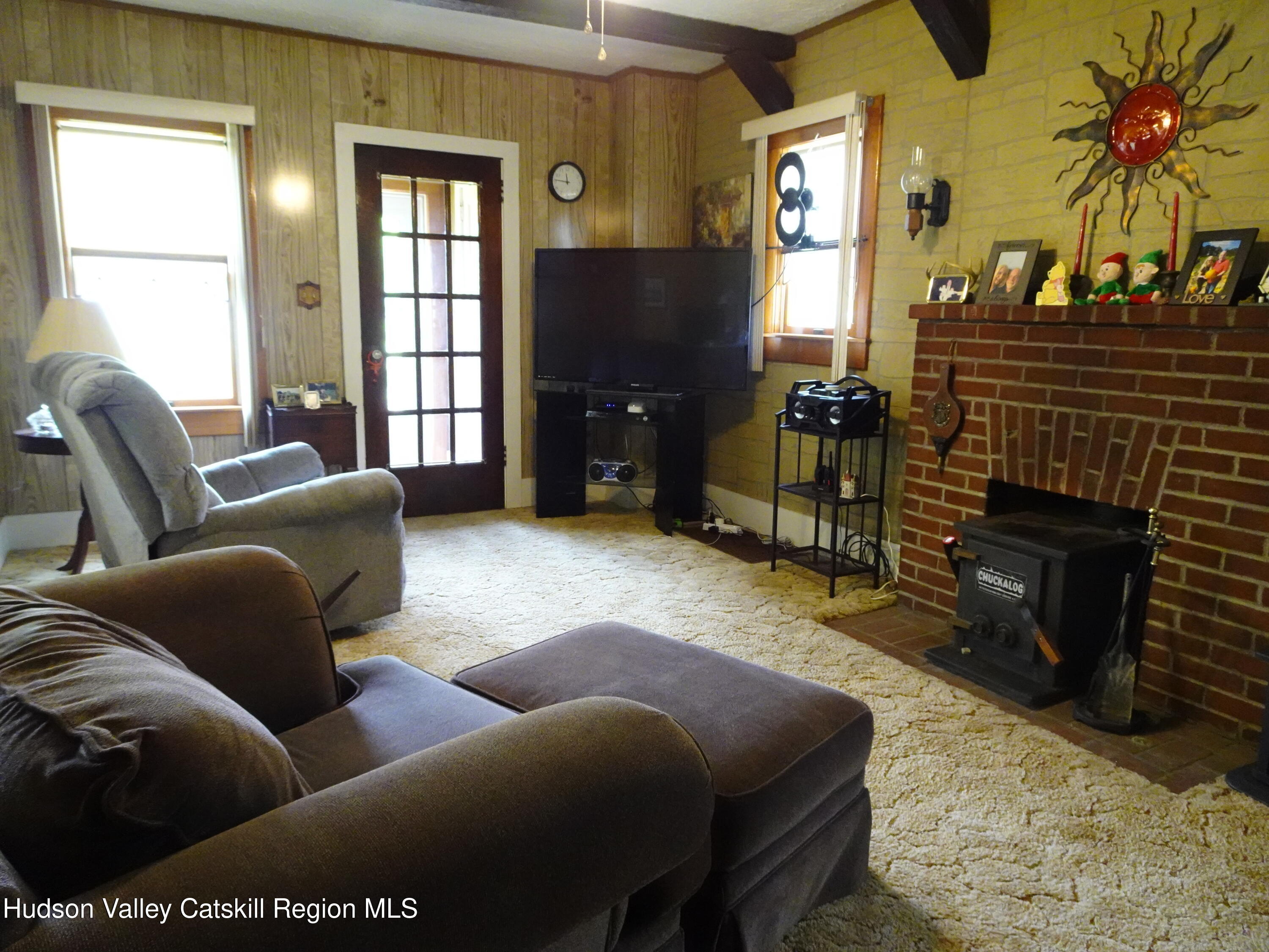 135 Millbrook Road Hudson, NY 12534 - Photo 13 of 40 a living room with furniture a window and a fireplace
