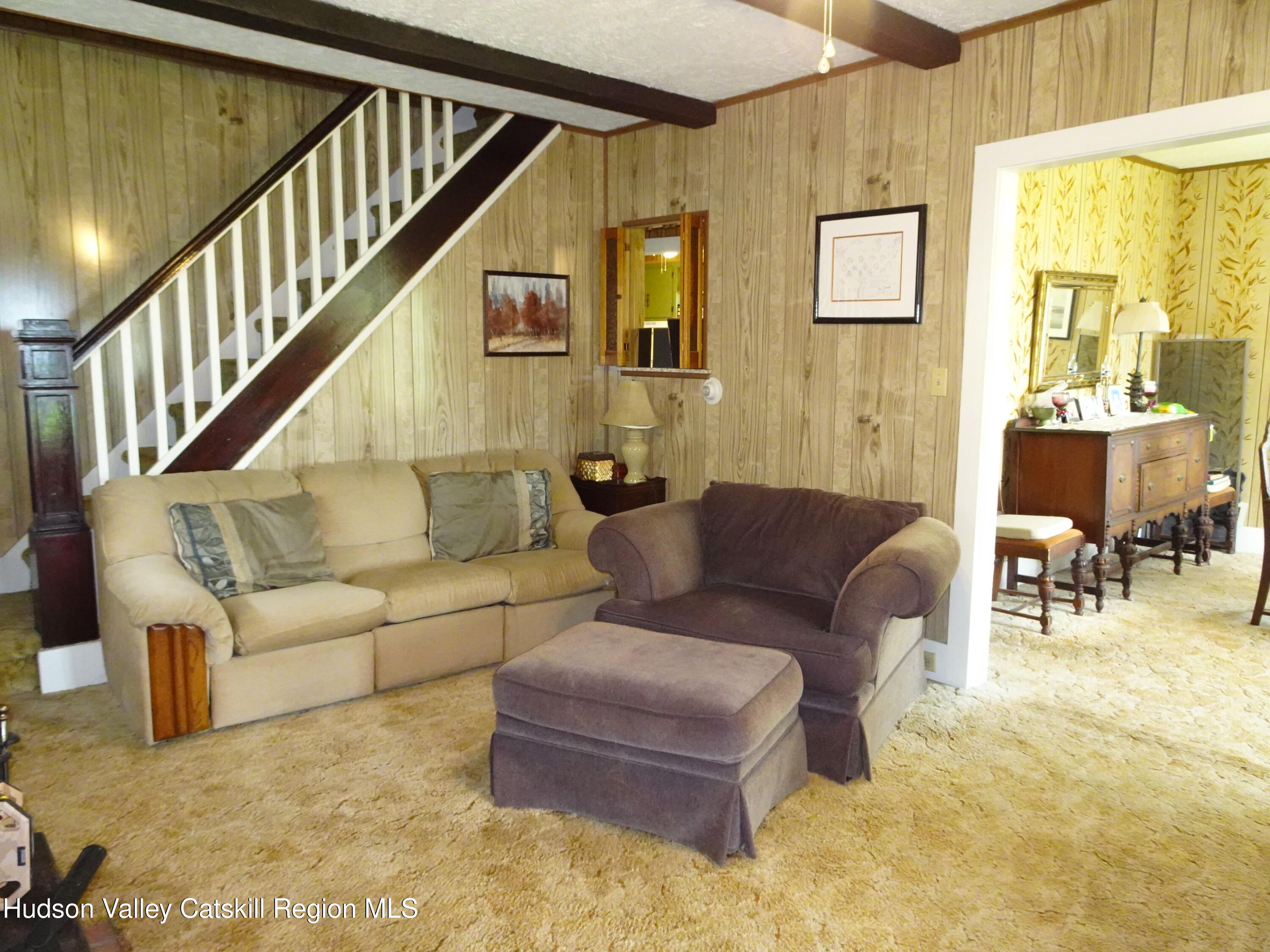 135 Millbrook Road Hudson, NY 12534 - Photo 16 of 40 a living room with furniture and a dining table with wooden floor
