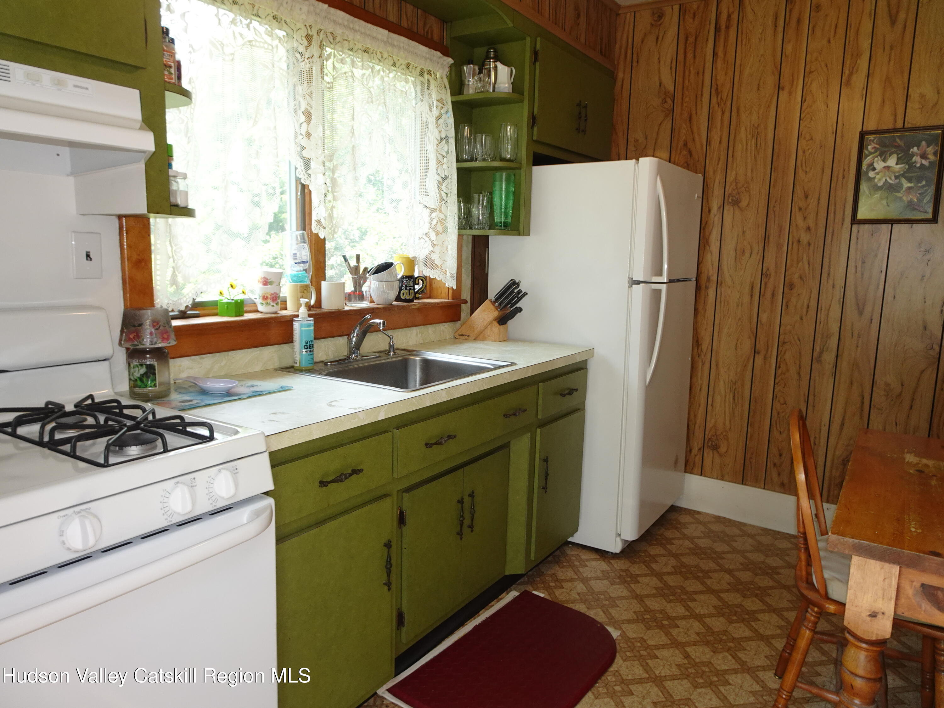 135 Millbrook Road Hudson, NY 12534 - Photo 21 of 40 a kitchen with a refrigerator and a sink