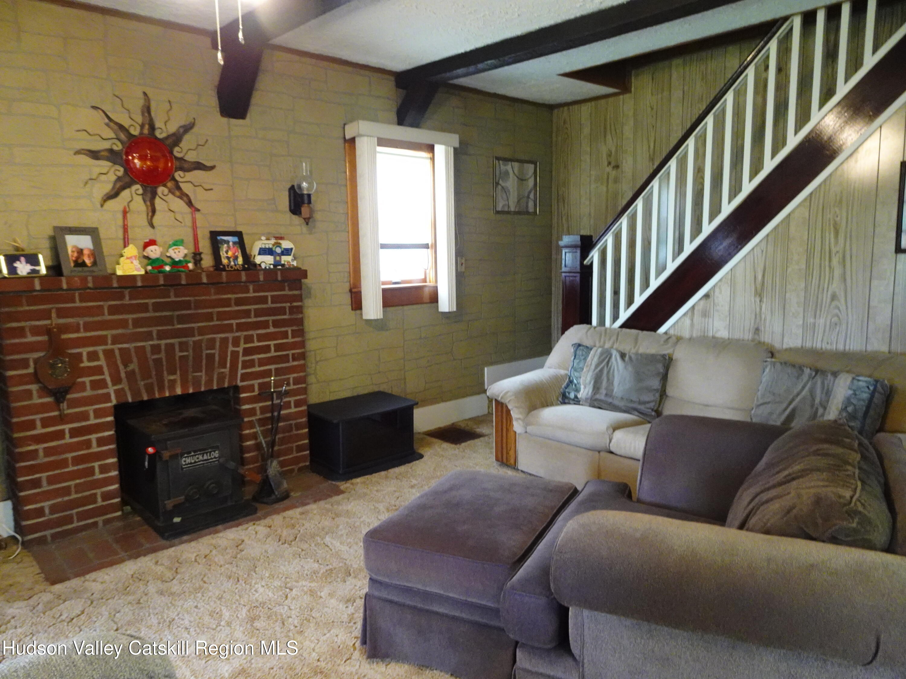 135 Millbrook Road Hudson, NY 12534 - Photo 27 of 40 a living room with furniture and a fireplace