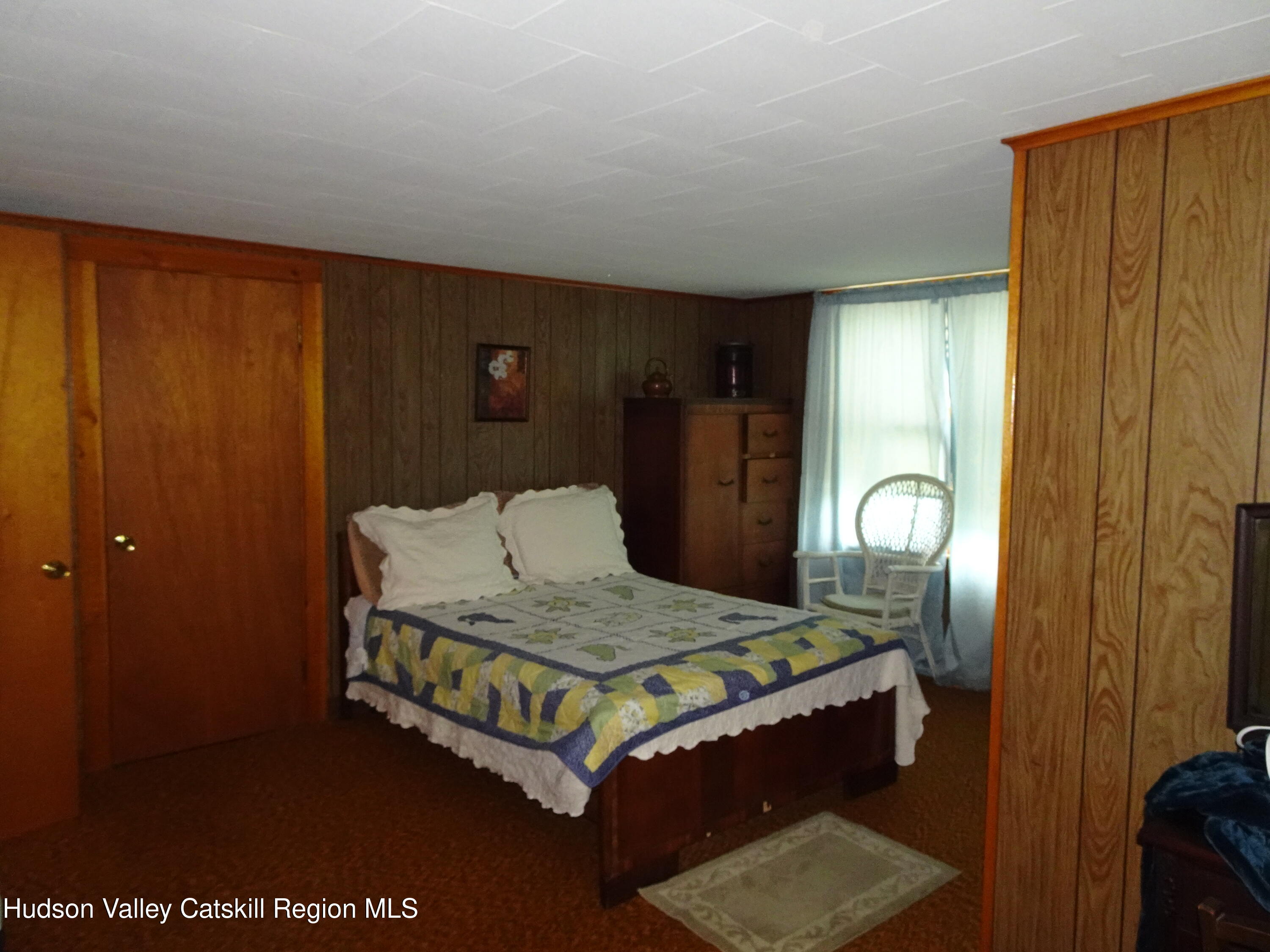 135 Millbrook Road Hudson, NY 12534 - Photo 30 of 40 a bedroom with a bed and wooden floor