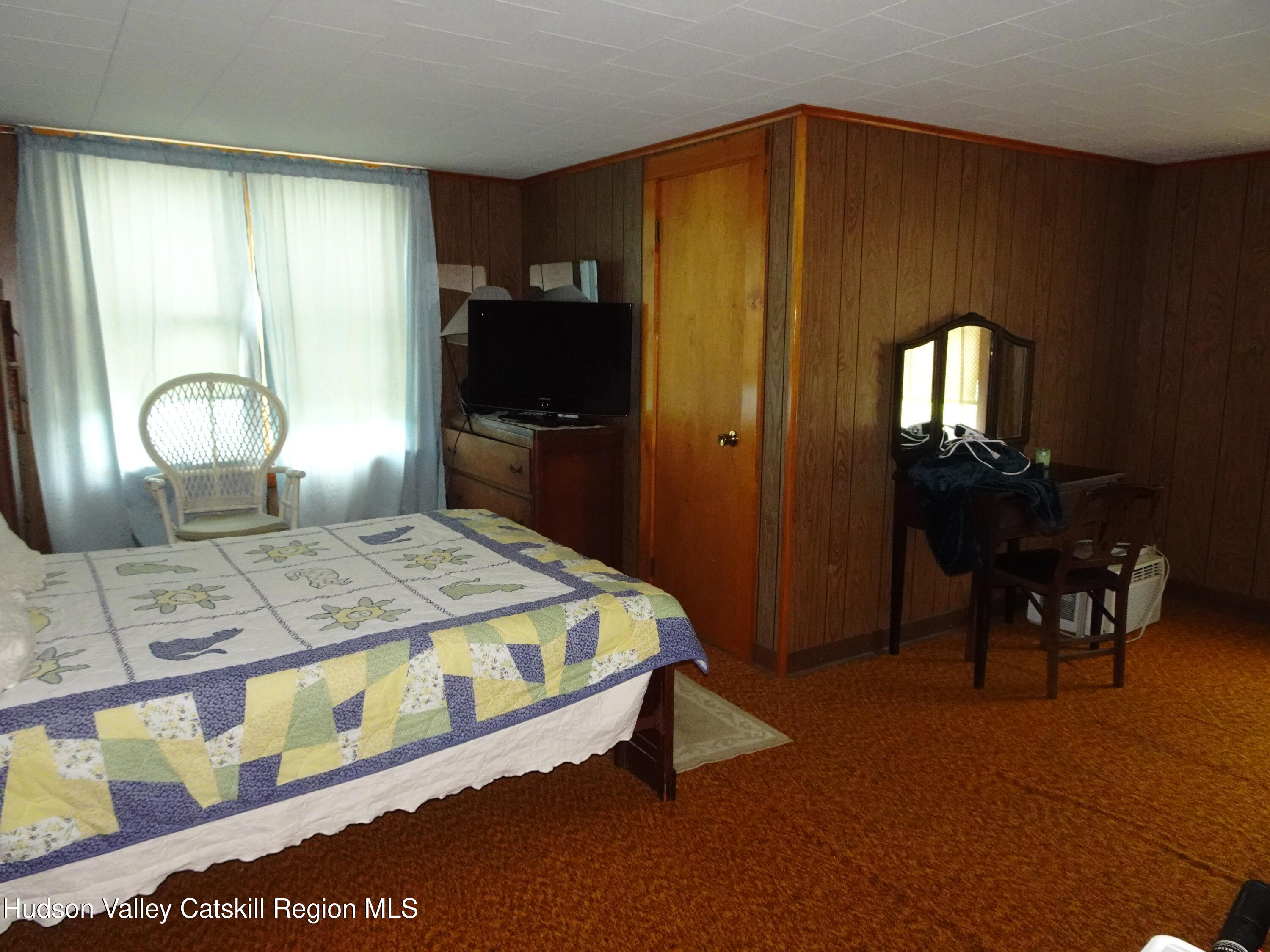 135 Millbrook Road Hudson, NY 12534 - Photo 31 of 40 a bedroom with a bed and a mirror