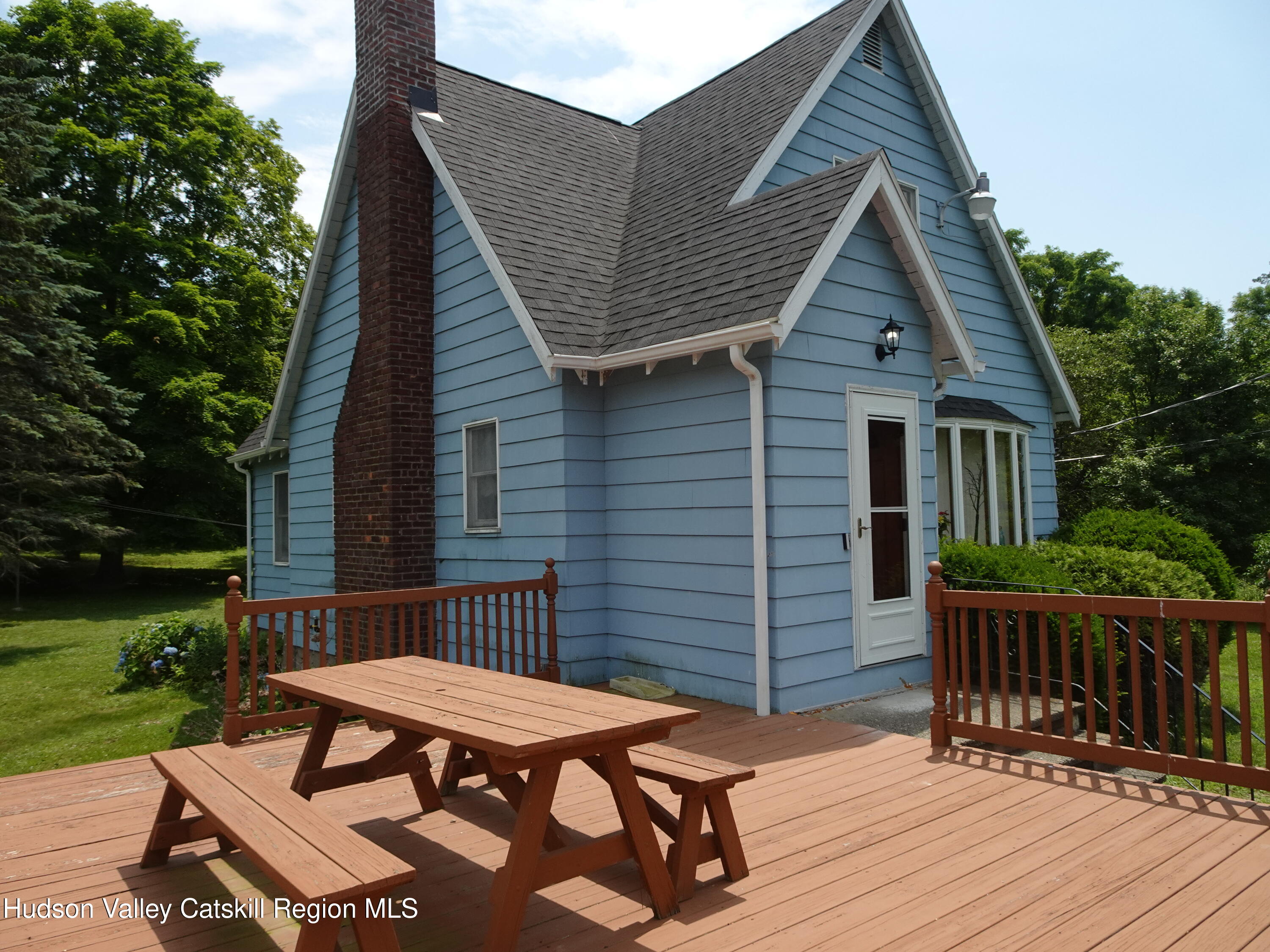 135 Millbrook Road Hudson, NY 12534 - Photo 7 of 40 a backyard of a house with wooden floor outdoor seating and yard in the back